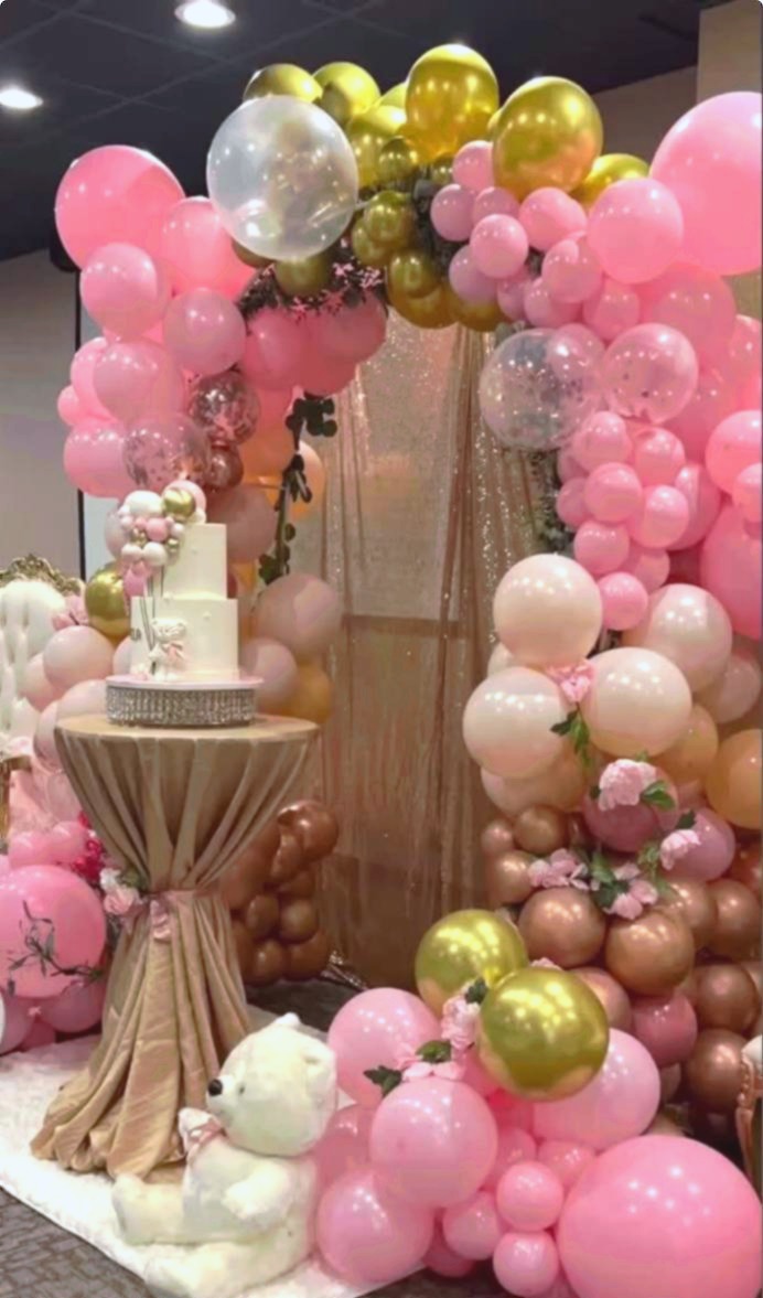 Pink and gold balloon arch with white teddy bear and cake table at Carissa Venue baby shower