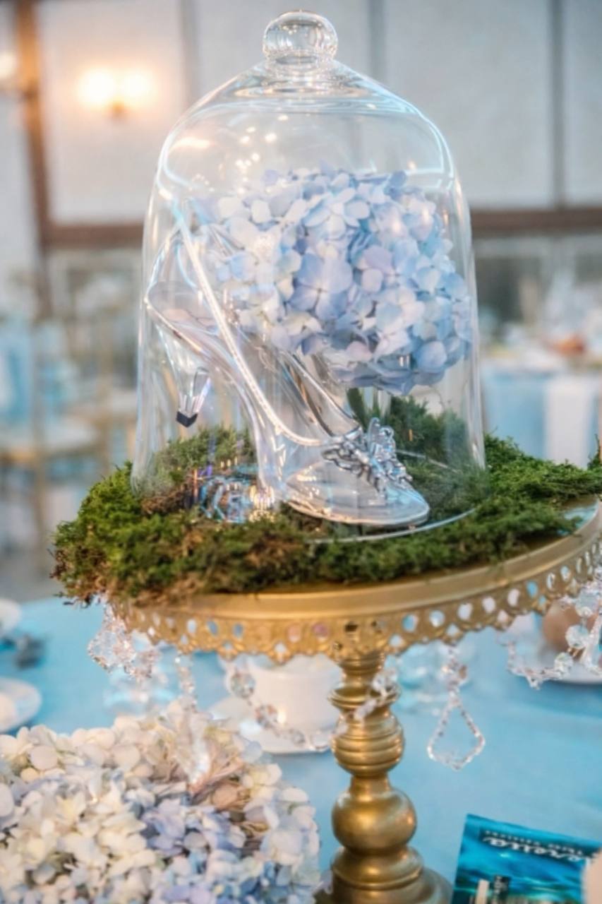 Cinderella glass slipper centerpiece under glass dome at Carissa Venue