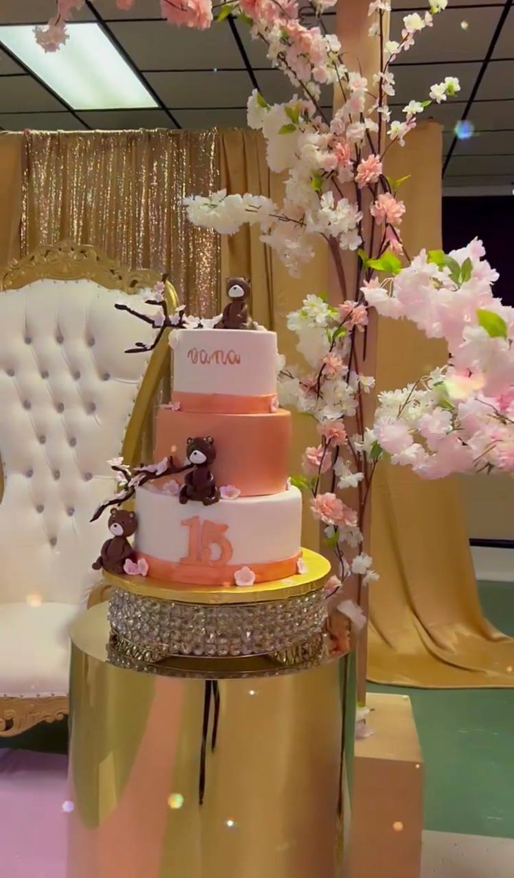 Three-tier quinceañera cake with teddy bears and cherry blossoms at Carissa Venue